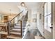 Bright foyer with dark hardwood flooring, staircase, and entry to dining and living rooms at 164 Inwood Walk, Woodstock, GA 30188