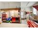 Functional garage space with workbench, storage, and classic red car at 164 Inwood Walk, Woodstock, GA 30188