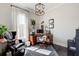 Well-lit home office with dark hardwood floors, stylish decor, and large window at 164 Inwood Walk, Woodstock, GA 30188