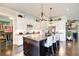 Open concept kitchen boasts a center island with bar stool seating and pendant lighting at 164 Inwood Walk, Woodstock, GA 30188