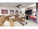 Cozy basement living room featuring a large sectional sofa, exposed brick wall, and entertainment center at 164 Inwood Walk, Woodstock, GA 30188