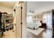 Bright main bedroom featuring a ceiling fan, hardwood floors, and a walk-in closet with ample shelving at 164 Inwood Walk, Woodstock, GA 30188