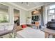 Charming screened porch with a view to the kitchen, decorated with a 'Home' sign and rustic accents at 164 Inwood Walk, Woodstock, GA 30188