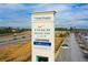 Sign of the Outlet Shoppes near the highway, advertising Coach, Nike, and more at 164 Inwood Walk, Woodstock, GA 30188