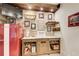Close up view of wet bar area, featuring sports memorabilia, exposed brick, and storage space at 164 Inwood Walk, Woodstock, GA 30188
