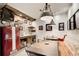Wet bar with vintage refrigerator, floating shelves, and industrial-style lighting above dining area at 164 Inwood Walk, Woodstock, GA 30188
