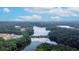 Scenic aerial view of lakefront community, dam, lush green trees, and blue skies with fluffy clouds at 3501 Great Sky Pkwy, Canton, GA 30114