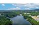 Scenic aerial view of lakefront community, lush green trees, and blue skies with fluffy clouds at 3501 Great Sky Pkwy, Canton, GA 30114