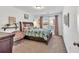 Bright bedroom with a patterned comforter, shelf decor, and natural light at 3501 Great Sky Pkwy, Canton, GA 30114