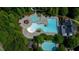 Aerial view of the community pool with multiple pools and lounge area surrounded by trees at 3501 Great Sky Pkwy, Canton, GA 30114