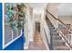 Inviting foyer with hardwood floors, staircase, and a bright blue front door adorned with a festive wreath at 3501 Great Sky Pkwy, Canton, GA 30114