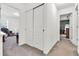 Bright hallway with closet leads into bedroom featuring carpeted floor and plenty of natural light at 3501 Great Sky Pkwy, Canton, GA 30114