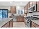 Stylish kitchen featuring stainless steel appliances, granite countertops, and wood-look floors at 3501 Great Sky Pkwy, Canton, GA 30114