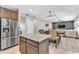 Open concept kitchen with stainless steel appliances, granite counters, an island, and seamless flow to dining and living areas at 3501 Great Sky Pkwy, Canton, GA 30114