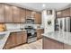 Kitchen featuring granite countertops, stainless steel appliances, light wood-look flooring and ample cabinet space at 3501 Great Sky Pkwy, Canton, GA 30114