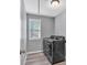 Efficient laundry room featuring modern washer and dryer units, ample space, and a window at 3501 Great Sky Pkwy, Canton, GA 30114