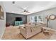 Comfortable living room with a large couch, ceiling fan, mounted television, and accent table with lighting at 3501 Great Sky Pkwy, Canton, GA 30114