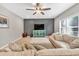Comfortable living room with a large couch, ceiling fan, mounted television, and accent furniture at 3501 Great Sky Pkwy, Canton, GA 30114