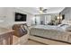 Main bedroom with bed, couch, dresser, and a large flat screen TV at 3501 Great Sky Pkwy, Canton, GA 30114