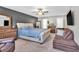 Main bedroom features a queen size bed, ceiling fan, and a cozy seating area at 3501 Great Sky Pkwy, Canton, GA 30114