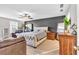 Spacious main bedroom with a ceiling fan, large windows, and comfortable seating area at 3501 Great Sky Pkwy, Canton, GA 30114