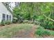 Picturesque backyard with a lush green lawn, mature trees, and privacy landscaping at 4485 Cadmium Dr, Cumming, GA 30040
