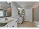 Bright bathroom with a double vanity, tiled floor, and separate shower with glass door at 4485 Cadmium Dr, Cumming, GA 30040