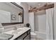 Bathroom featuring stylish vanity, framed mirror, and a bathtub with unique wood beam accent at 4485 Cadmium Dr, Cumming, GA 30040