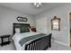 Cozy bedroom featuring a dark wood bed frame, a vintage mirror, and neutral wall color at 4485 Cadmium Dr, Cumming, GA 30040