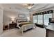 Light-filled bedroom with floral bedding, tray ceiling, and comfortable seating bench at 4485 Cadmium Dr, Cumming, GA 30040