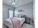 Inviting bedroom with light purple accents, a ceiling fan, and neutral walls at 4485 Cadmium Dr, Cumming, GA 30040