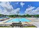 Expansive community pool area with multiple swimming areas, lounge chairs, and clear blue skies at 4485 Cadmium Dr, Cumming, GA 30040