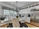 Cozy dining area adjacent to kitchen with white cabinets, a chandelier, and natural light from the windows at 4485 Cadmium Dr, Cumming, GA 30040