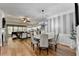 Open-concept dining area with stylish striped wallpaper, elegant chandelier, and hardwood floors at 4485 Cadmium Dr, Cumming, GA 30040