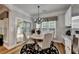 Charming dining area features a round table, chandelier, and sunlit window views, with deck access at 4485 Cadmium Dr, Cumming, GA 30040