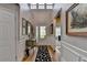 Bright foyer featuring hardwood floors, high ceilings, elegant wainscoting, and decorative accents at 4485 Cadmium Dr, Cumming, GA 30040
