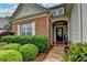 Inviting brick home with a covered front entry, complemented by manicured bushes and stone pathway at 4485 Cadmium Dr, Cumming, GA 30040