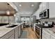 Open kitchen with an island, modern appliances, and an adjacent dining area, creating a cozy space at 4485 Cadmium Dr, Cumming, GA 30040