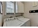 Functional laundry room with washer, dryer, and storage cabinets for convenience at 4485 Cadmium Dr, Cumming, GA 30040