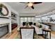 Spacious living room flowing into the kitchen, featuring a fireplace and comfortable seating at 4485 Cadmium Dr, Cumming, GA 30040