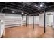 Finished basement with laminate floors, exposed ceiling, and open space for flexible use at 490 E Pharr Rd, Decatur, GA 30030