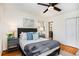 Bedroom with wood floors, comfortable bed and decor with easy access to ensuite bathroom at 490 E Pharr Rd, Decatur, GA 30030