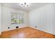 Bright bedroom featuring light-colored wood paneling, hardwood floors, and large windows at 490 E Pharr Rd, Decatur, GA 30030