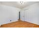Bright bedroom featuring light-colored wood paneling, hardwood floors, and a closet at 490 E Pharr Rd, Decatur, GA 30030