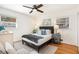 Comfortable bedroom with a ceiling fan, hardwood floors, and light-filled windows at 490 E Pharr Rd, Decatur, GA 30030
