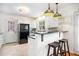 Modern kitchen with stainless steel appliances, white cabinets, and breakfast bar at 490 E Pharr Rd, Decatur, GA 30030
