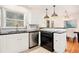 Modern kitchen with stainless steel appliances, white cabinets, and breakfast bar at 490 E Pharr Rd, Decatur, GA 30030