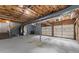 Spacious basement with exposed ceiling, and garage doors leading outside at 800 Breckinridge Sw Rd, Marietta, GA 30064