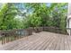 Spacious wooden deck with metal railing, and view of the surrounding greenery at 800 Breckinridge Sw Rd, Marietta, GA 30064