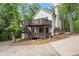 Two story home with driveway and a two level wooden deck with metal railings at 800 Breckinridge Sw Rd, Marietta, GA 30064